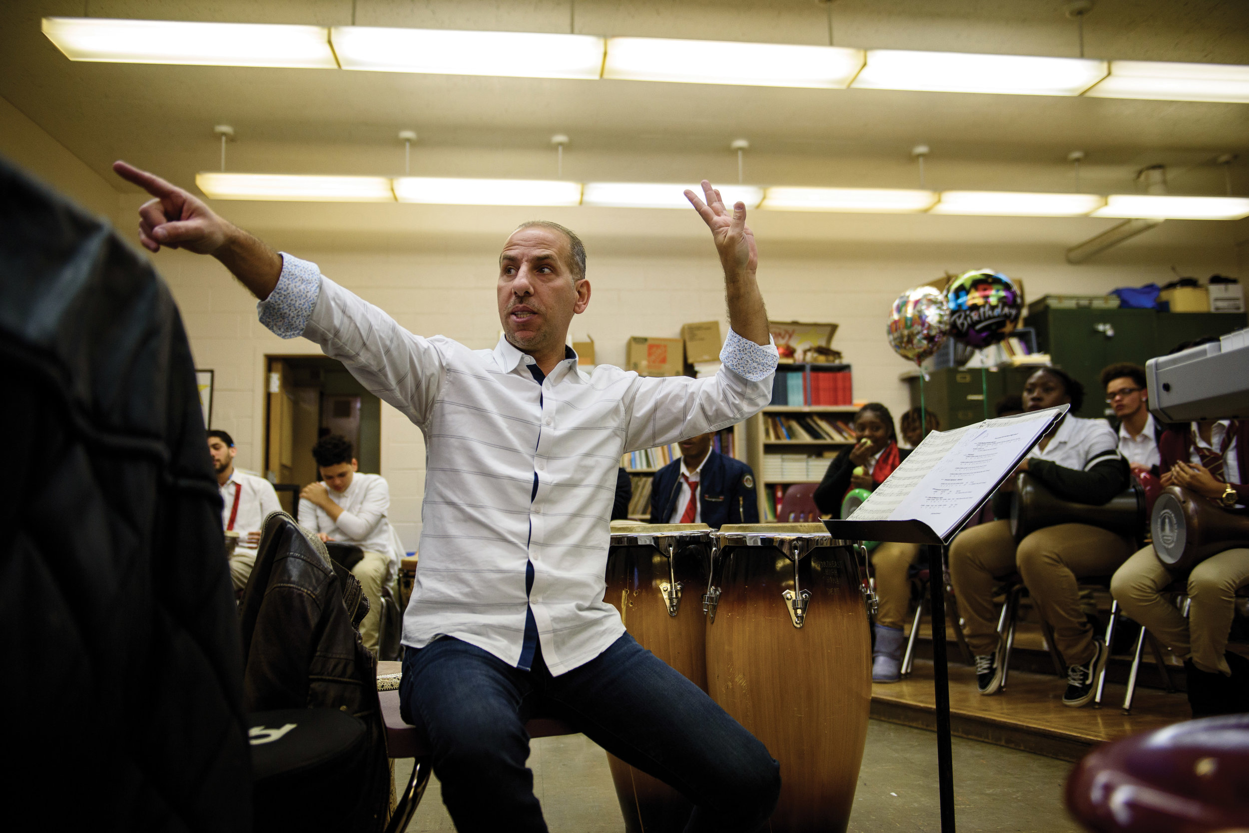   Hafez Kotain instructing a drum class at Northeast High School  