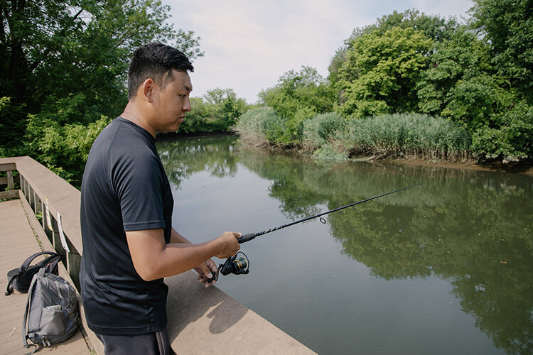 Leo&nbsp; Sheng, of the popular YouTube channel “Extreme Philly Fishing,” kills the northern snakeheads he catches at John Heinz Refuge. Photography by Rachael Warriner.