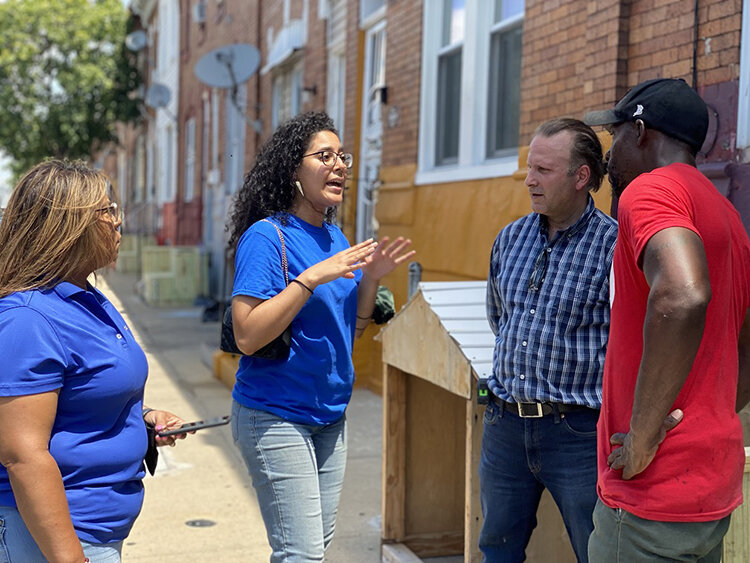 Photography courtesy of Esperanza. Esperanza volunteers talk with community members about COVID-19 vaccines and community greening projects.