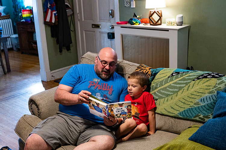 Mike reads the children’s book “Our Skin: A First Conversation About Race” to Wesley.