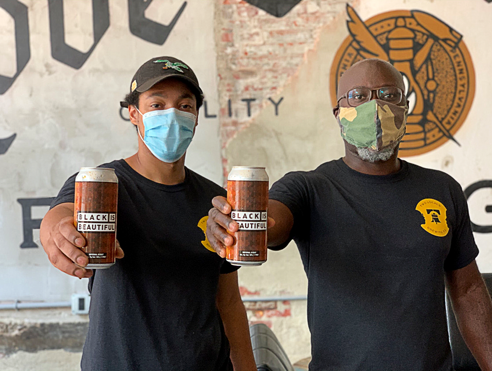 Brothers Rich (left) and Mengistu Koilor pose with their Black is Beautiful beer. Photograph courtesy of Two Locals Brewing Company.