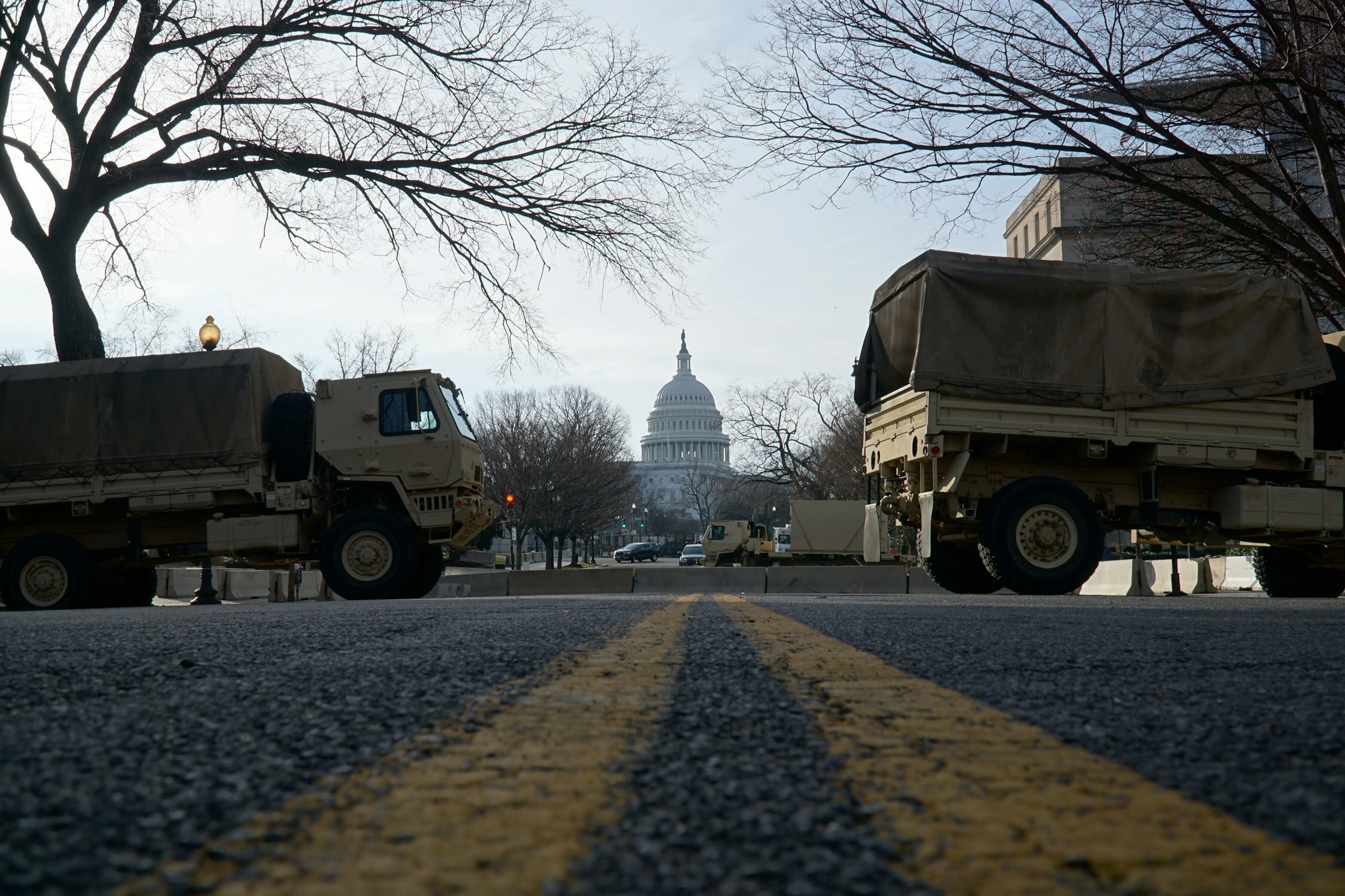 National Guard trucks parked on the street near the US Capitol. Photograph courtesy of Ian Hutchinson on Unsplash.com.