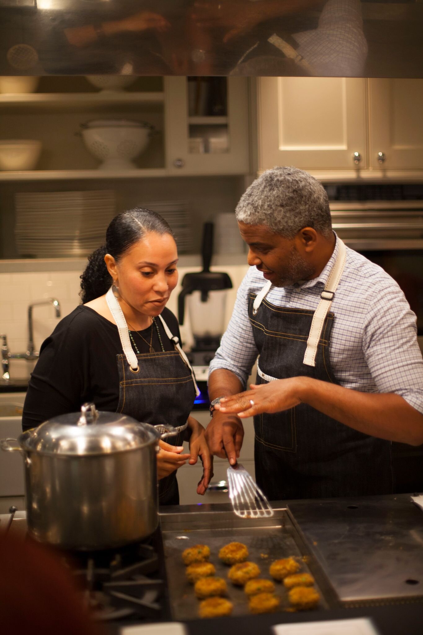 Elizabette Andrade with partner and Co-Owner, Erich Smith teach a cooking class with their products. Photography courtesy of Cooking Alchemy.