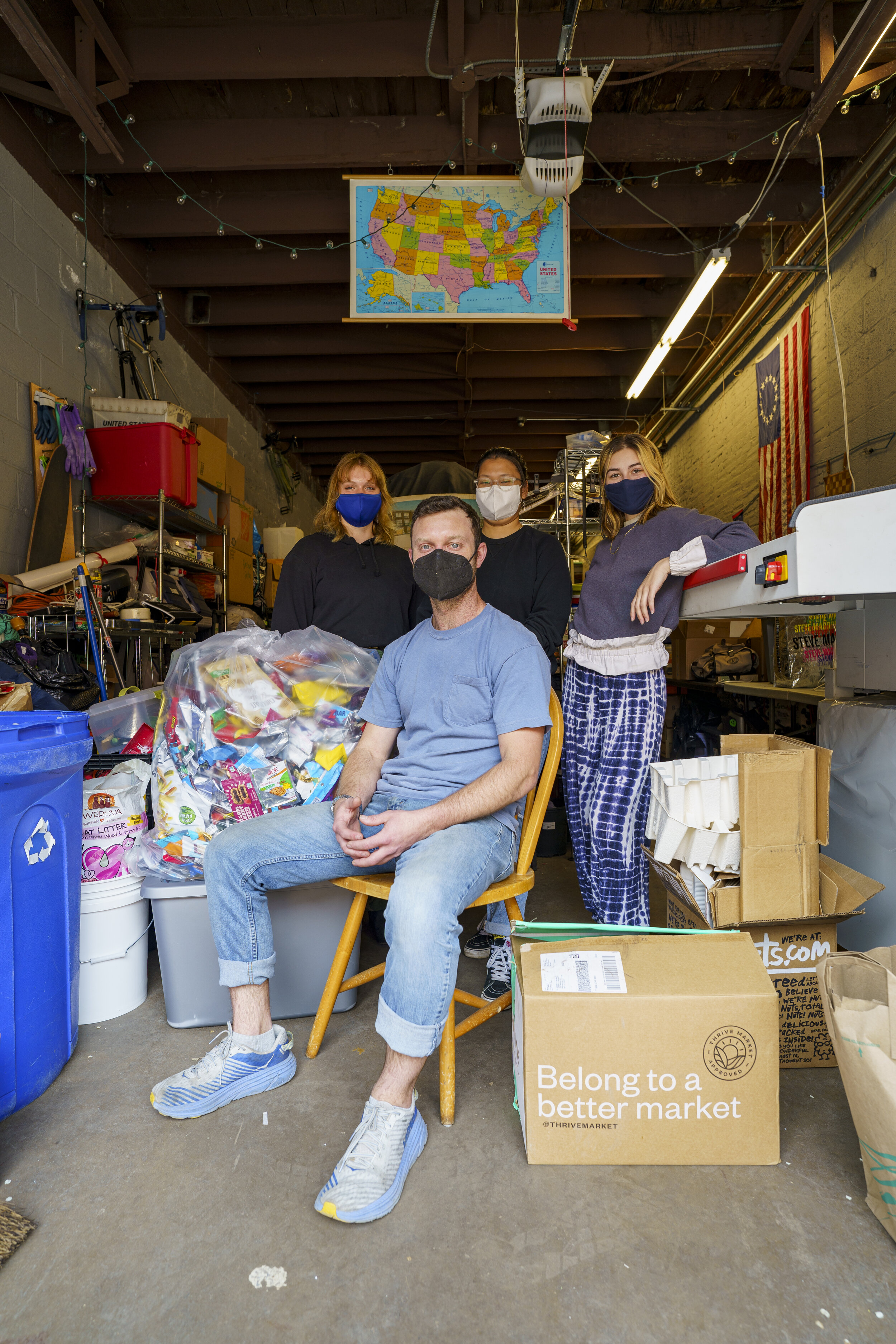 Matt Siegfried, (seated) co-founder of Rabbit Recycling, alongside employees (left to right) Haven DeAngelis, Textiles Coordinator; Dax Cohen, Marketing &amp; Social Media Coordinator; and Cailynn Chase Operations and Outreach Coordinator. Photography by Drew Dennis