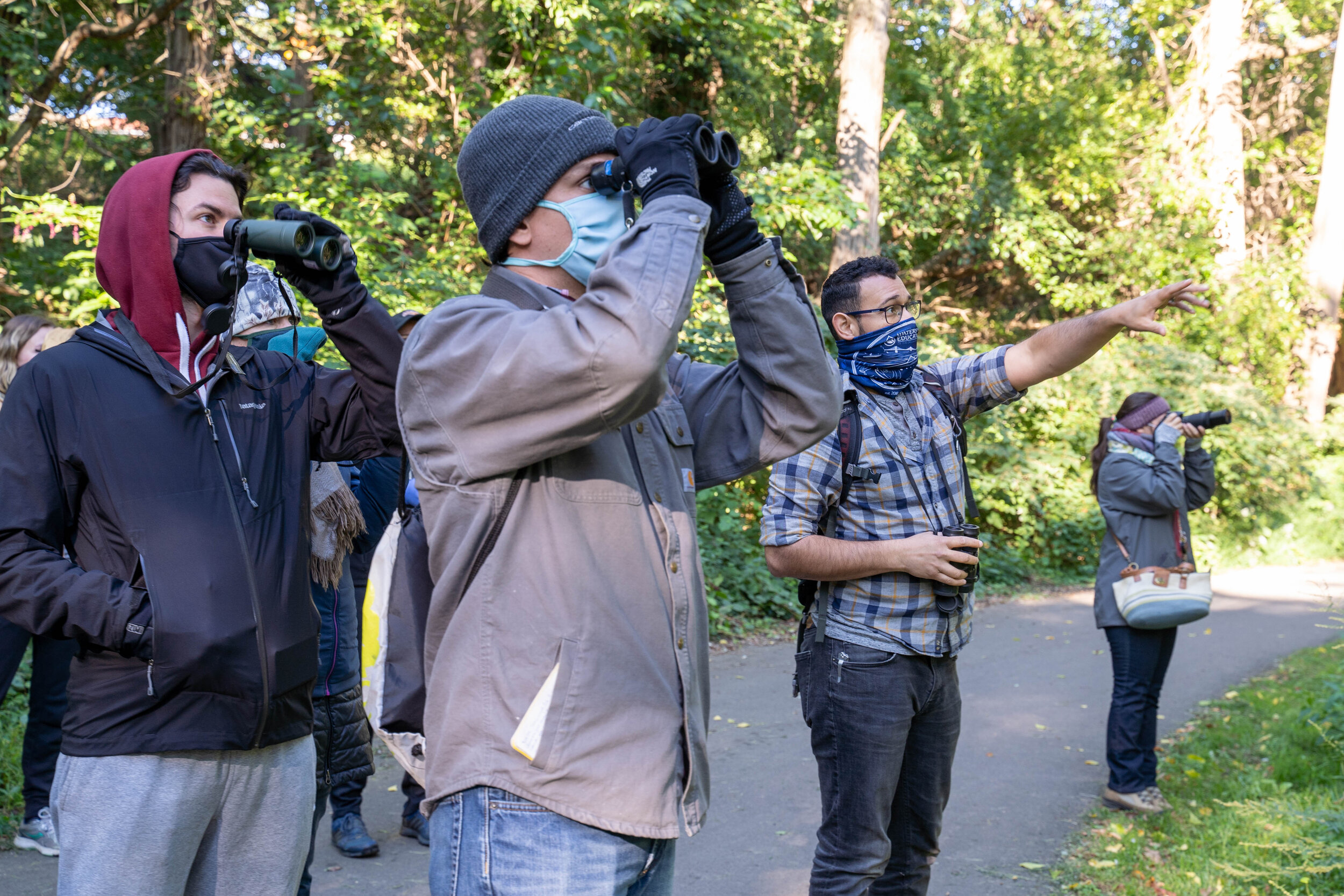 Visitors enjoy a bird-watching tour of Tacony Creek Park with a guide who can identify birds in both Spanish and English. Photography by Milton Lindsay.