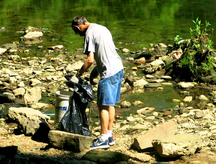 A member of the Friends of Pennypack collects litter during a 2016 cleanup. Photograph courtesy of Alan Trachtenberg.