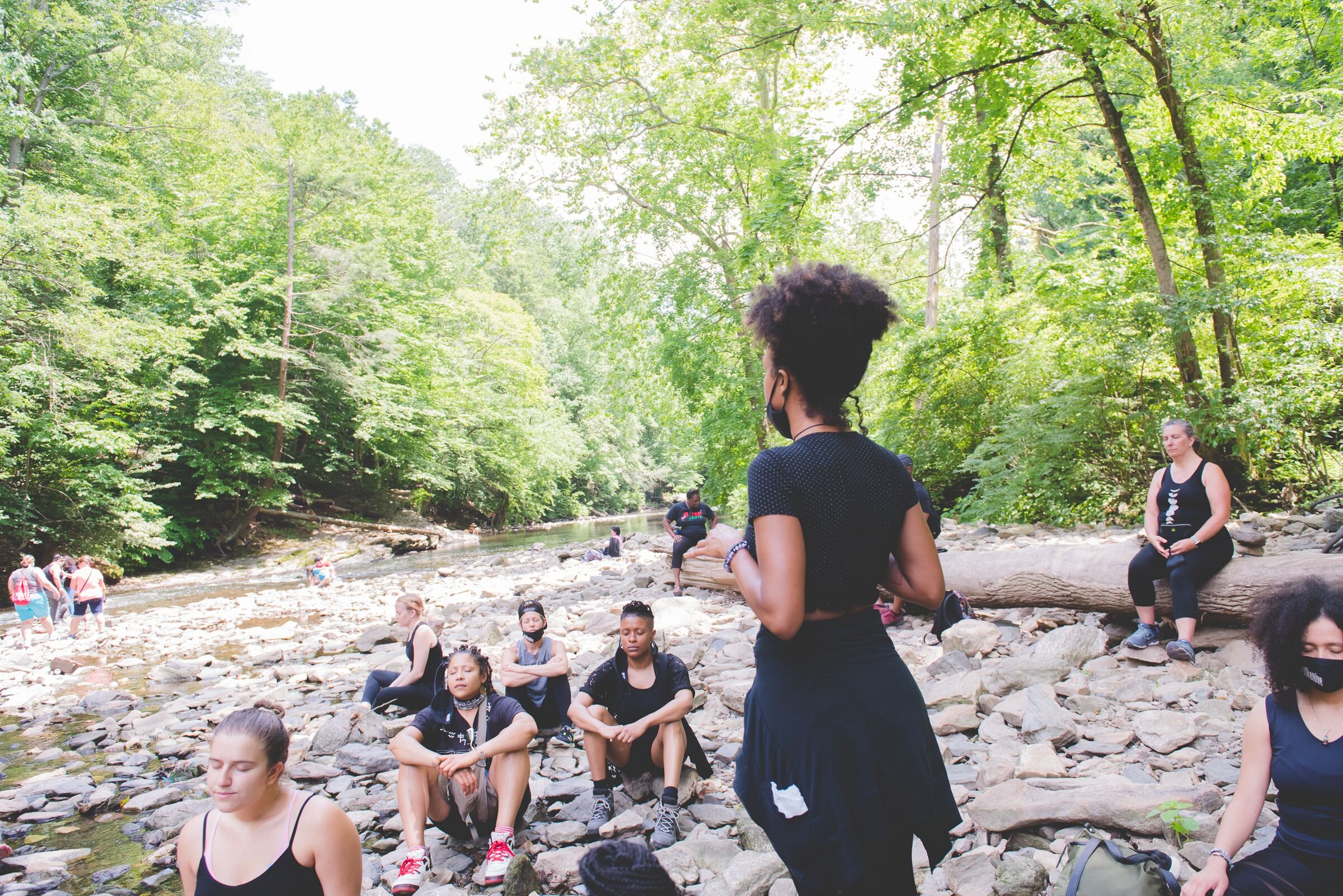 Hike + Heal members meditate beside the Wissahickon Creek. Photographs courtesy of Cathie at BeauMonde Originals.
