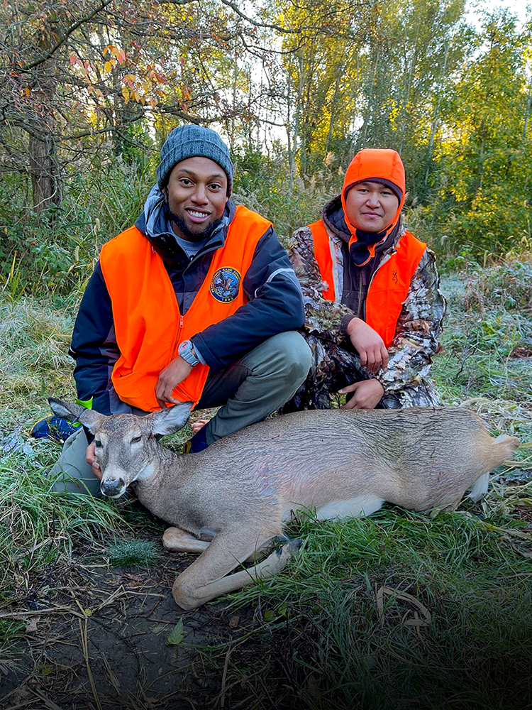 Two men with harvested doe