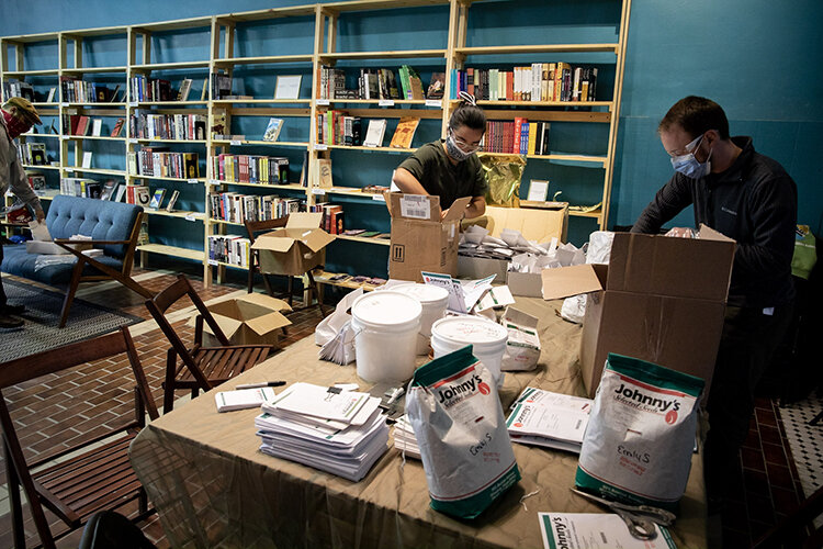  Volunteers sort seed donations inside of West Philadelphia’s Making Worlds Bookstore.  Credit: Rachael Warriner 