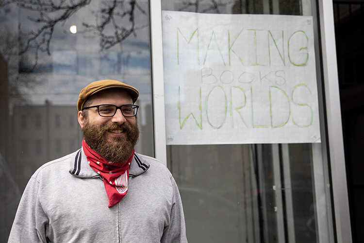  Nathan Kleinman smiles while taking a break from sorting donations.  Credit: Rachael Warriner 