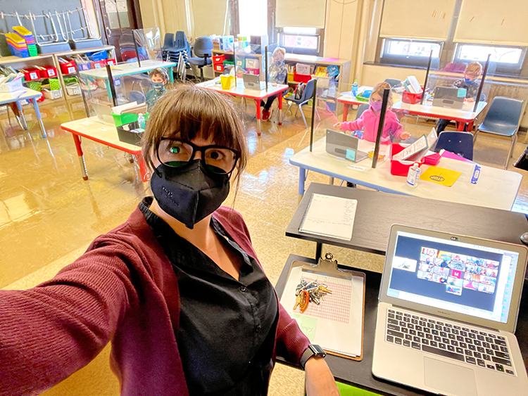 a teacher with mask on in classroom