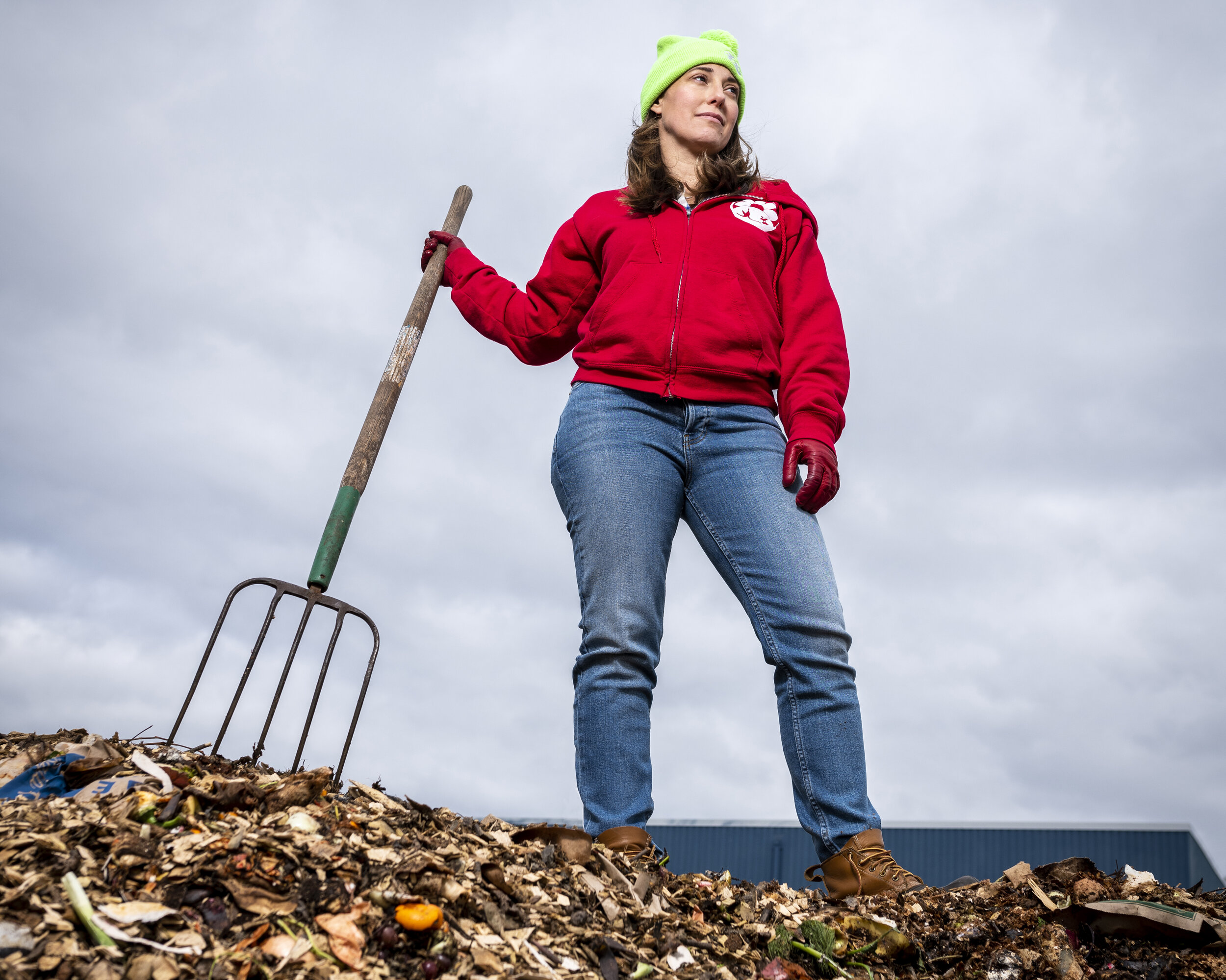 Michele Bloovman, co-founder of Circle Compost, stands atop a pile of organic waste. 