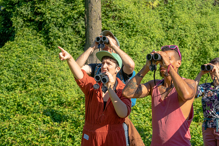 Philly Queer Birders founder Elise Greenberg (front left) and walk leader Edge (front right) watch birds in FDR Park at a Saturday meetup. Photography by Drew Dennis.