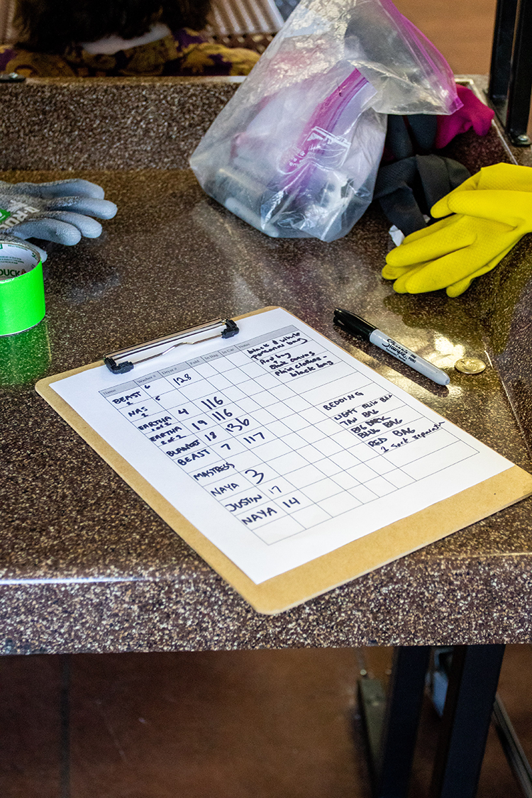 A clipboard is used to keep track of names of laundry service recipients.