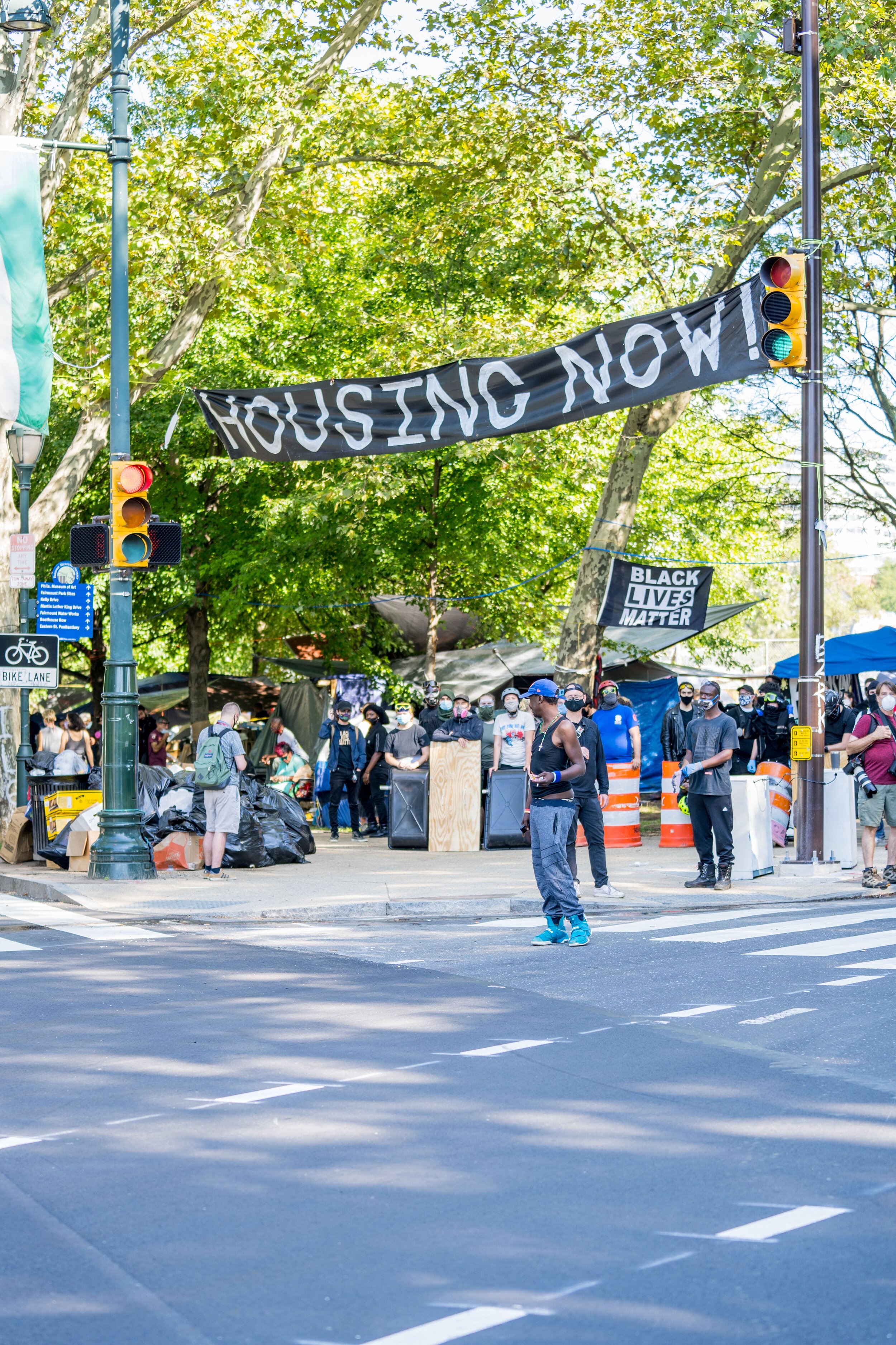 Protesters gather along the Benjamin Franklin Parkway in August to demand housing.Photography by Drew Dennis.