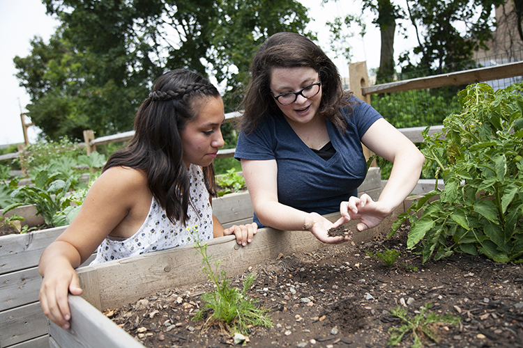  Rising junior Eliana Uriona and visiting assistant professor of chemistry Vanessa Boschi, Ph.D., conduct soil productivity research in Villanova University’s research garden. (Photo courtesy of Villanova University) 