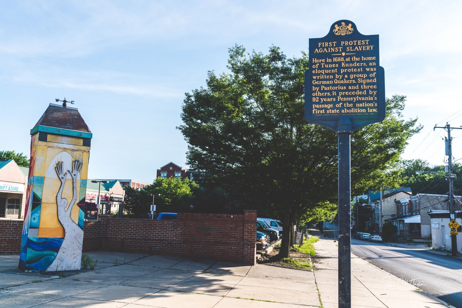A historical marker indicating the site of the first protest against slavery in Germantown.